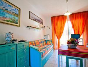 a living room with a couch and a table at Résidence Suarella in Saint-Florent