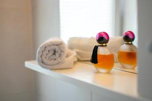a shelf with two bottles of soap and towels at Apartment IRENA with Bikes included in Pula