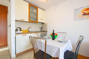 a kitchen with a table and chairs in a room at Apartment IRENA with Bikes included in Pula