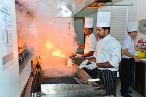 a group of chefs standing in a kitchen preparing food at Sea Port in Negombo