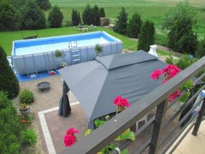 an overhead view of a patio with a tent and a pool at Dom między jeziorami i morzem in Bychowo