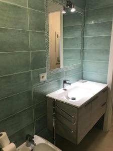 a bathroom with a sink and a mirror at APPARTAMENTI del DUCA in Ferrara