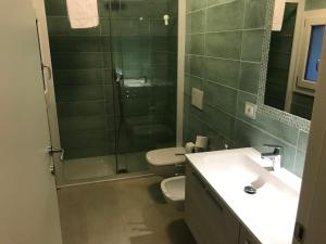 a bathroom with a toilet and a shower and a sink at APPARTAMENTI del DUCA in Ferrara +23 photos