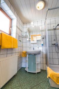 a bathroom with a sink and a shower at Hotel Gasthof zur Linde in Mariahof