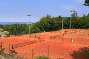 a row of tennis courts on a tennis court at Poiano Garda Resort Hotel in Garda