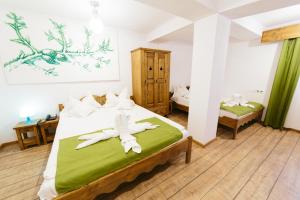 a bedroom with a bed with towels on it at Hotel Superski in Cavnic