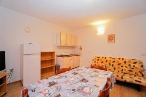 a room with a kitchen and a table and a refrigerator at Apartment Daniela in Savudrija