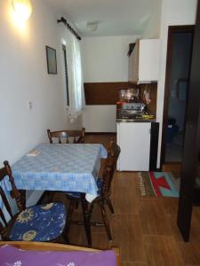a kitchen with a table and chairs in a room at Studio Apartment Carli in Savudrija