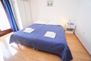 a bedroom with a bed with two towels on it at Apartment Daniela in Savudrija