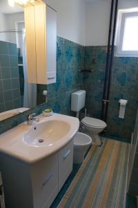 a bathroom with a sink and a toilet at Apartment Vilma in Savudrija +14 photos