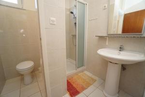 a bathroom with a toilet and a sink and a shower at Apartment Mandica in Savudrija +30 photos