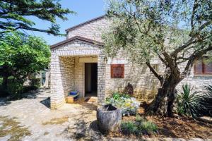 a brick house with a tree in front of it at Villa Ana in Savudrija