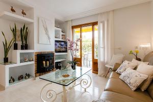 a living room with a couch and a glass table at Apartment Rosmare in Alcudia