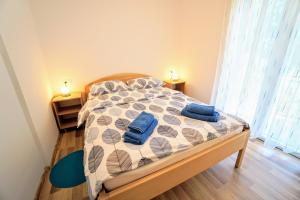 a bedroom with a bed with blue towels on it at Apartment Nino Savudrija in Bašanija