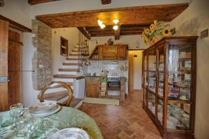 a large kitchen with a counter and a stove at Casa Margherita 3 by PosarelliVillas in Piegaio