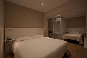 A bed or beds in a room at Onorati Hotel