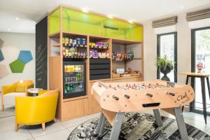 a store with a table and a game room at Aparthotel Adagio access Colombes La Défense in Colombes