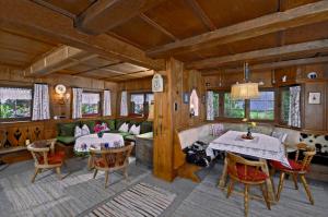 a living room with two tables and a couch at Ferienhäuser Reither Almen in Reith im Alpbachtal