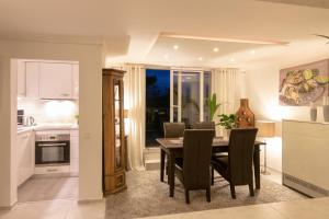 a kitchen and dining room with a table and chairs at Ferienwohnungen Riese - Weitblick in Arnsberg +9 photos