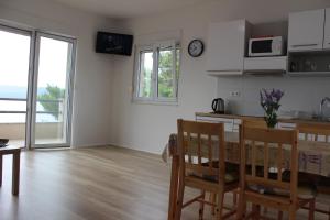 a kitchen and dining room with a table and chairs at Villa Marina in Omiš