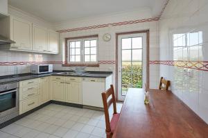 une cuisine avec une table en bois et une salle à manger dans l'établissement Relaxing Villa w/pool up to 6 people Cascais, à Cascais