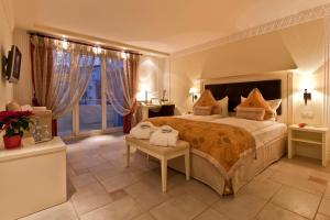 a bedroom with a large bed and a large window at Boutiquehotel La Casa in Tübingen +42 photos