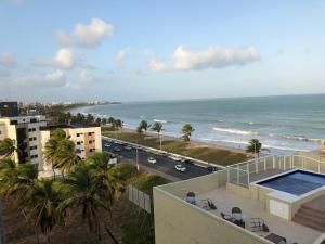 a view of the ocean from the balcony of a building at Flat Mar Belo Intermares in Cabedelo
