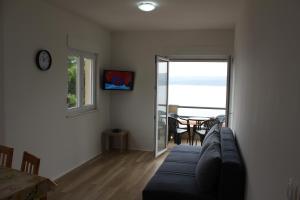 a living room with a couch and a table and a window at Villa Marina in Omiš