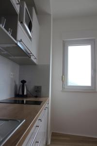 a kitchen with a window next to a kitchen counter at Villa Marina in Omiš