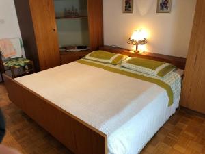 a bedroom with a large bed with a lamp on it at Mariella in Bašanija