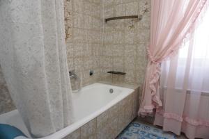 a bathroom with a tub and a pink shower curtain at Mariella in Bašanija +55 photos