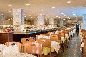 una fila di tavoli e sedie in un ristorante di htop Royal Star & SPA #htopFun a Lloret de Mar