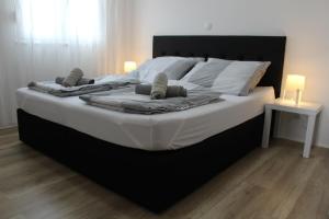 a large bed with two pillows on it in a bedroom at Villa Marina in Omiš