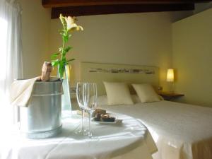 a bedroom with a bed with a table with a flower on it at El Mirador de las Monjas in Trujillo