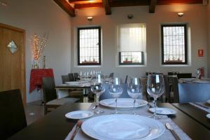 a table with wine glasses on top of it at El Mirador de las Monjas in Trujillo