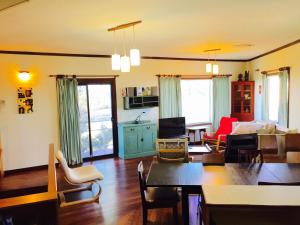 a living room with a couch and a table at The Kite Beach House in Guilderton