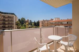 a balcony with a white table and two chairs at htop Amatista #htopBliss in Lloret de Mar