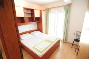 Postel nebo postele na pokoji v ubytování Apartments Knežević