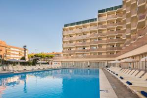 a swimming pool in front of a hotel at htop Amatista #htopBliss in Lloret de Mar