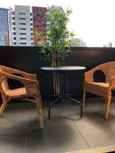 a table and two chairs and a table with a plant at Fantastic Southbank Apartment in Melbourne