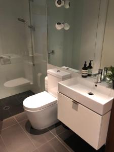 a bathroom with a toilet and a sink and a shower at Fantastic Southbank Apartment in Melbourne