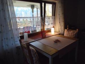 a dining room table with a candle and a window at Non Smoking Traudel Engelken in Neckargemünd