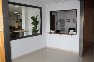 a mirror on a wall in a room with a table at Hotel Mar de Aragón in Caspe