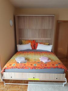 a bedroom with a large bed with a headboard at Ferienwohnung Regina in Müllrose