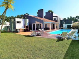 a villa with a swimming pool and a house at MSC Holidays in Charneca