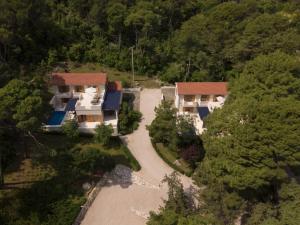 an aerial view of a house in the woods at Private luxury Villa BIANCO on Solta for up to 10 persons, heated pool, free parking, very close to the beach! FREE Kajak & Mountainbikes, GREAT living area & privacy! in Rogač