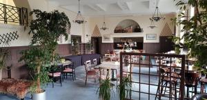 a restaurant with tables and chairs and potted plants at The Devonshire House Hotel-Free Parking in Liverpool