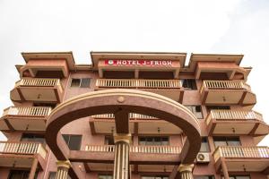 a hotel building with an arch in front of it at Hotel Jfrigh in Kampala