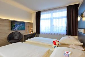 Postel nebo postele na pokoji v ubytování Roomingtons Lüneburger Heide