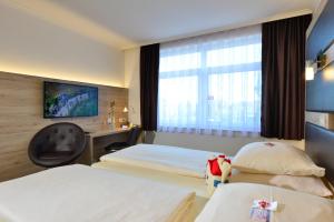 Кровать или кровати в номере ACHAT Hotel Lüneburger Heide